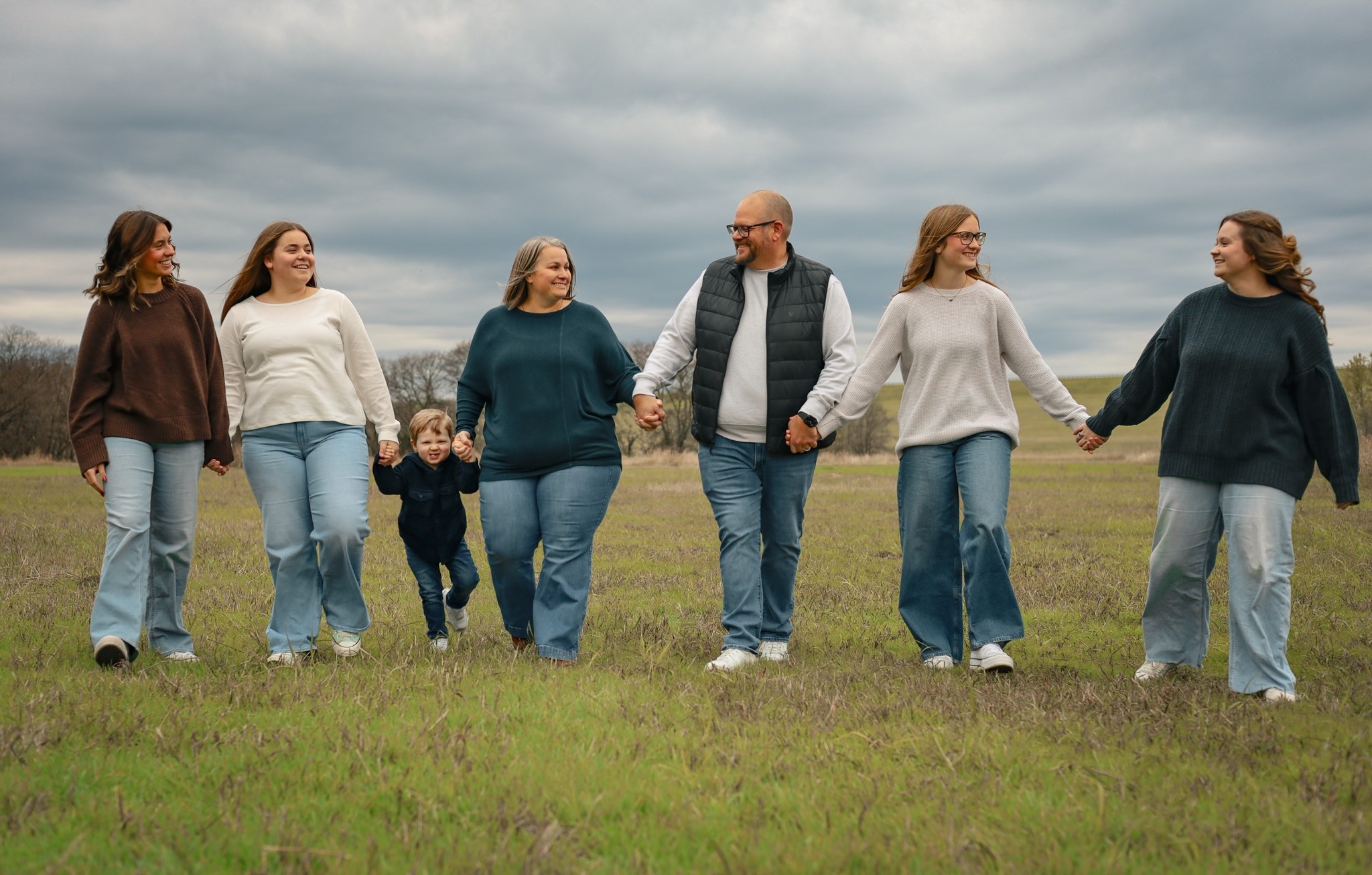 A family walking together across an open field.